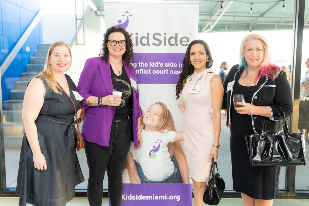 Guests beside the KidSide banner at the 2023 Judicial Reception
